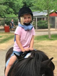 Portrait of girl riding horse