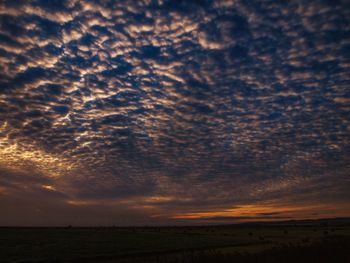 Scenic view of field against sky during sunset