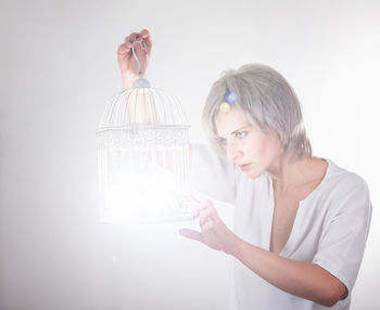 Portrait of beautiful woman standing against white background