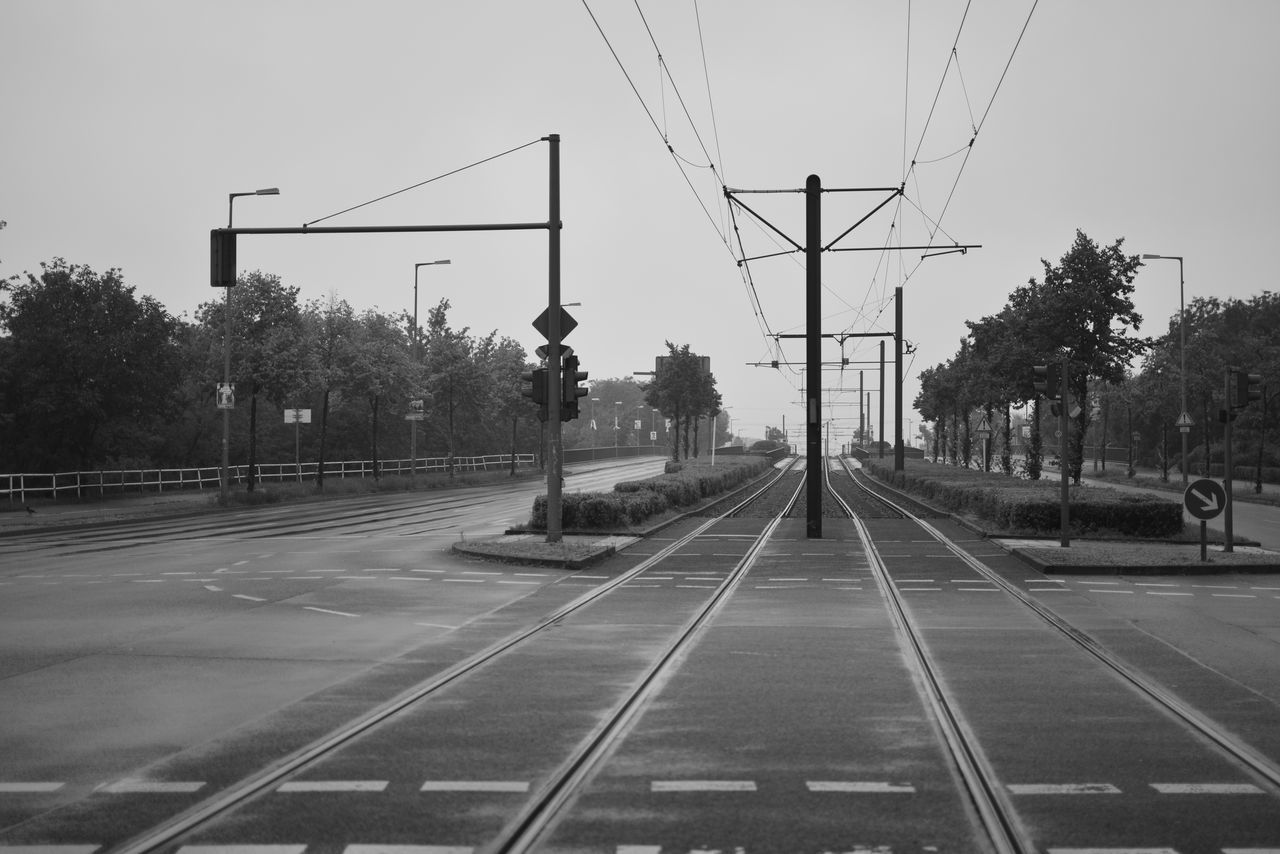 transportation, railroad track, rail transportation, cable, tree, the way forward, day, electricity pylon, outdoors, no people, sky, nature, clear sky