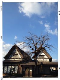 Low angle view of buildings against cloudy sky
