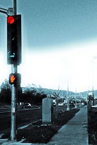 Road sign against blue sky