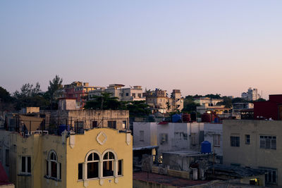 Buildings in city against clear sky