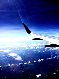 Cropped image of airplane flying over landscape