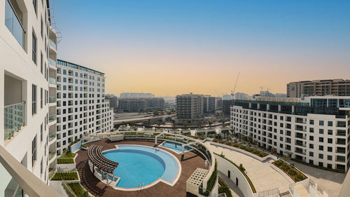 Buildings in city against clear skies in abu dhabi