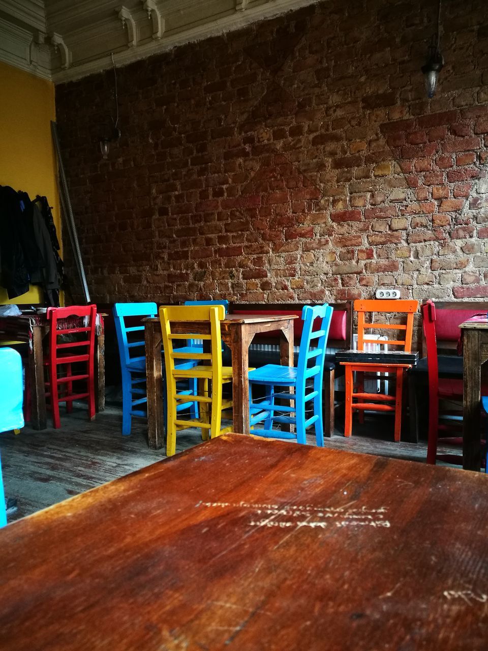 brick wall, no people, indoors, table, chair, illuminated, architecture, day