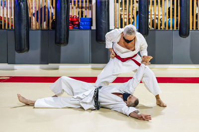 Men wearing face masks while fighting in health club