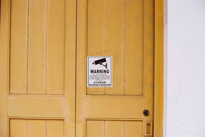 Close-up of information sign on door