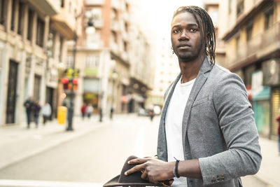 Young man standing in city