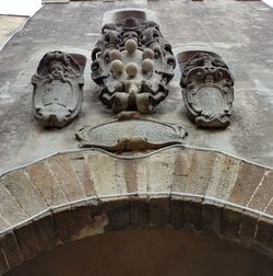 Low angle view of statue against built structure