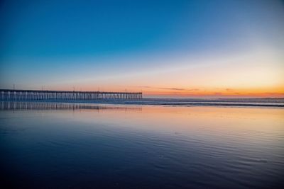 Scenic view of beach against sky during sunset