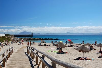 People on beach against sky