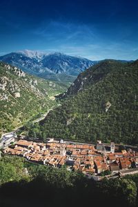 High angle view of houses and mountains against clear sky