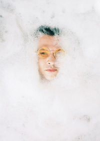 Portrait of a man in foam bath 