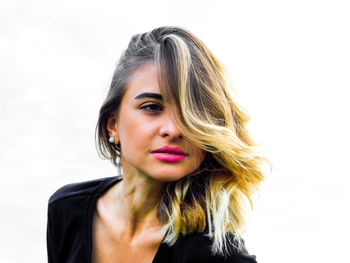 Close-up of young woman against white background