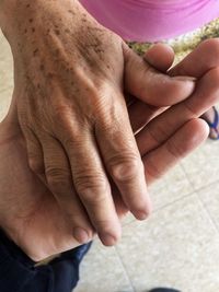 Midsection of woman holding hands