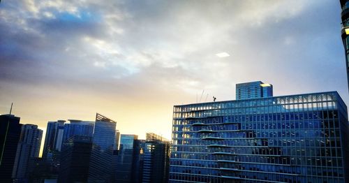 Low angle view of buildings against sky during sunset
