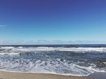 Scenic view of sea against blue sky