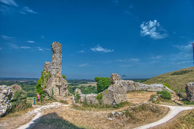 Panoramic view of old ruins against blue sky