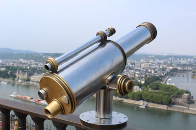 Coin-operated binoculars against cityscape