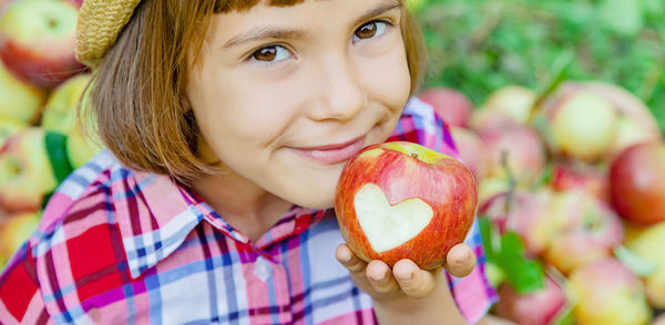 Portrait of smiling girl with apple