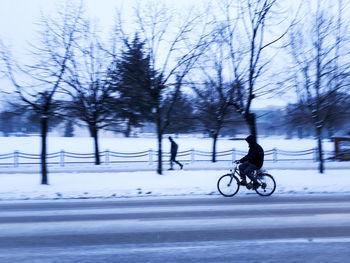 Man with bicycle in winter