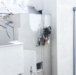 People working at construction site against building