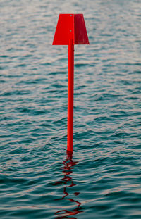 High angle view of red umbrella on water