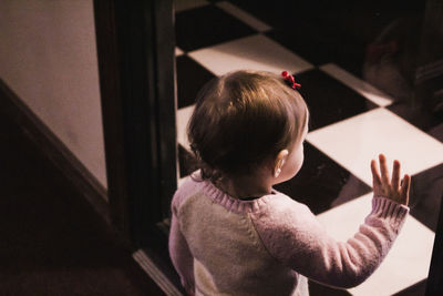 Rear view of boy standing at home