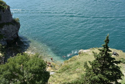 High angle view of man on cliff by sea