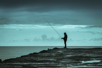 Side view of a man fishing at sea