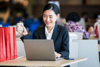 Mid adult woman using mobile phone