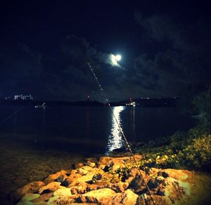 Scenic view of lake against sky at night