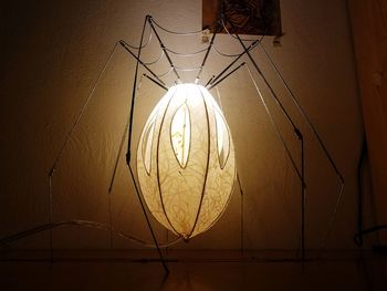 Low angle view of illuminated pendant light hanging from ceiling