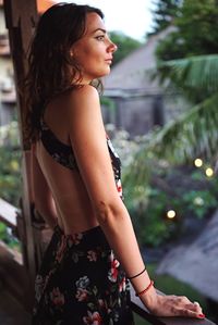 Woman looking away while standing in balcony