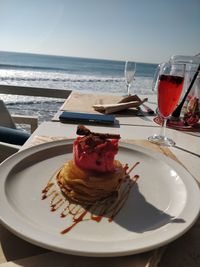 High angle view of ice cream on table by sea