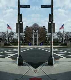 Road sign against cloudy sky