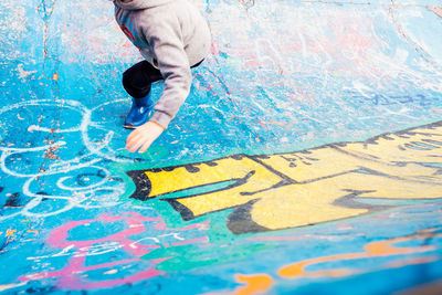 High angle view of man painting on wall in swimming pool