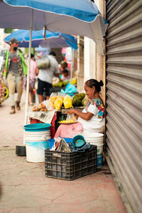 Portrait of old woman selling traditional food on street market in mexico.