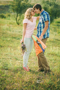 Young couple walking on field