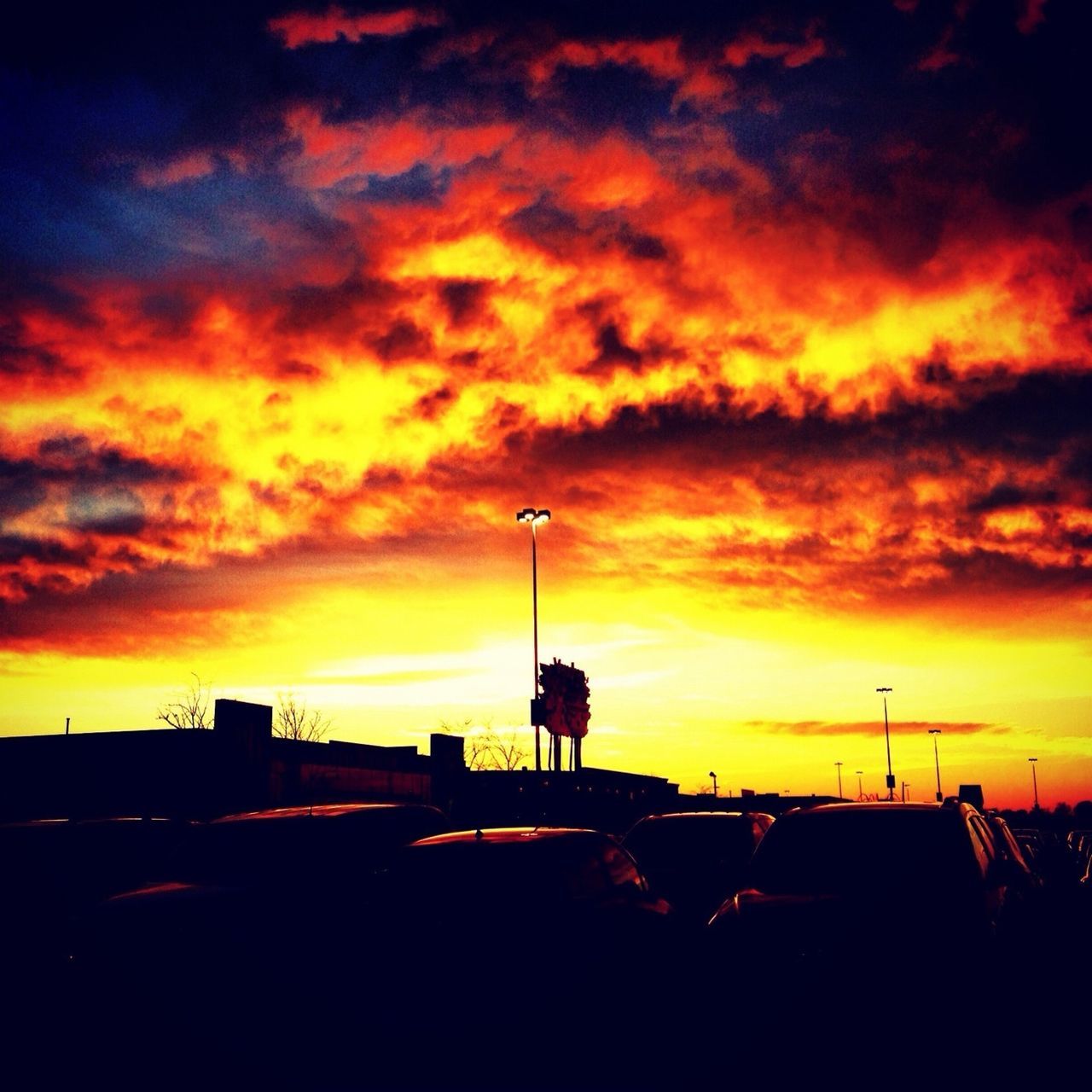 sunset, sky, orange color, cloud - sky, silhouette, dramatic sky, cloudy, built structure, cloud, architecture, street light, beauty in nature, building exterior, nature, scenics, moody sky, weather, outdoors, overcast, dusk