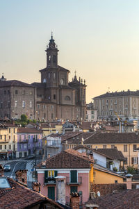 View of buildings in city at sunset