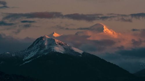 Scenic view of snowcapped mountains against sky during sunset