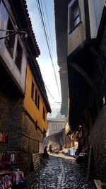 Canal amidst buildings in city against sky