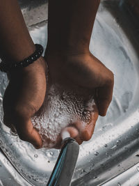 High angle view of man hand on wet table