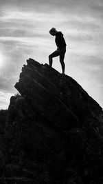 Side view of a woman standing on rock