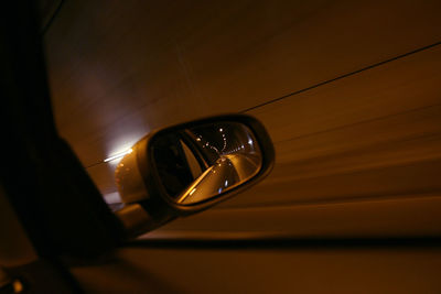 Close-up of eyeglasses on side-view mirror