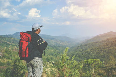 Man standing on mountain against sky