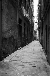 Cobblestone street amidst buildings in city