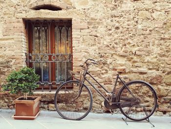 Bicycle against brick wall of old building